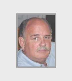 Man with mustache and light blue shirt.